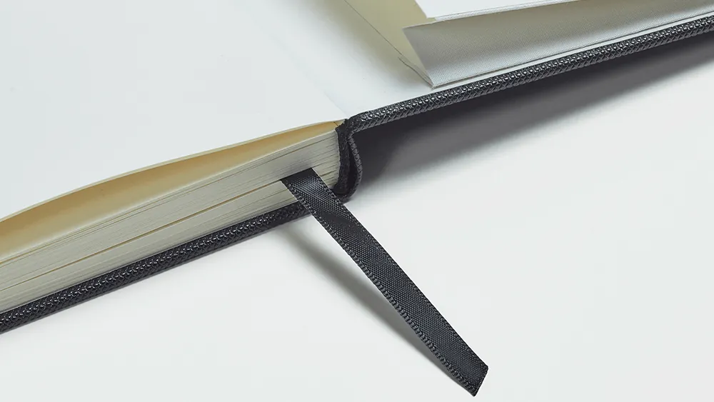 Ribbon bookmark at the stitched spine of the planner