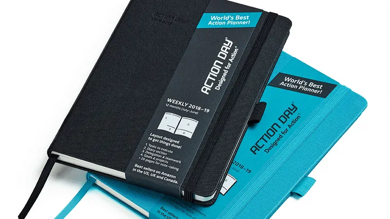 Black and turquoise Action Day planners with ribbon bookmarks and paper bands
